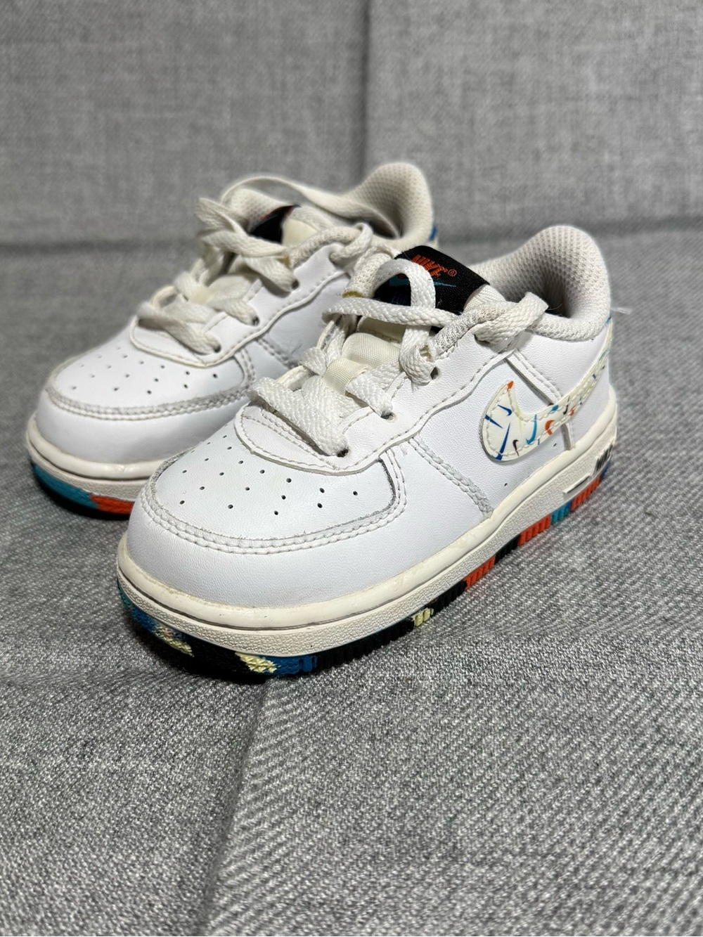 Nike Kids White Sneakers with Multicolor Swoosh and Outsole